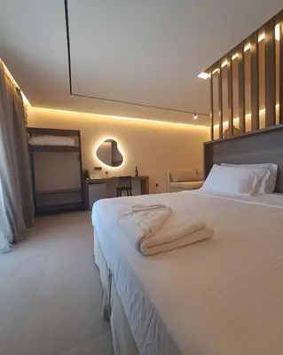 a bedroom with a large white bed with towels on it at Castella Luxe in Loutro