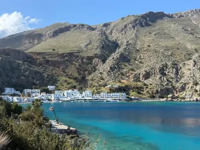 a view of a large body of water with mountains at Castella Luxe in Loutro