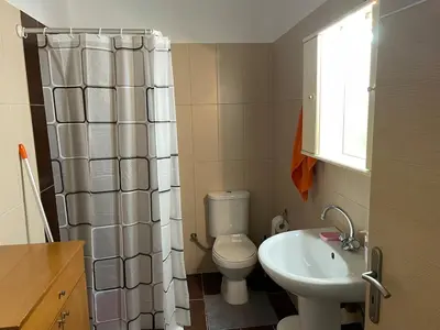 a small bathroom with a toilet and a sink at Ifigenias House in Kissamos