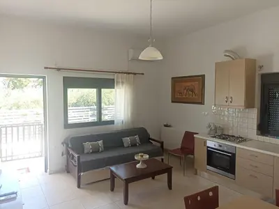 a living room with a couch and a table at Ifigenias House in Kissamos