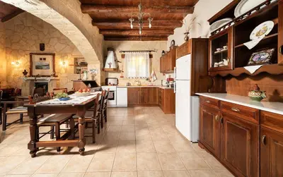 a large kitchen with a table and a dining room at Villa Levedeli in Nerokhórion