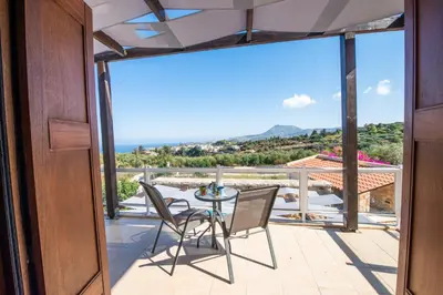 a view from the balcony of a house with a table and chairs at Villa Anna Gaia In Tzivaras in Tsivarás