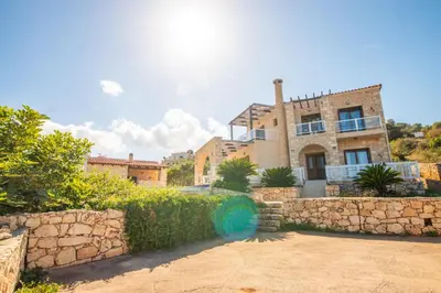 a large brick house with a stone wall at Villa Anna Gaia In Tzivaras in Tsivarás