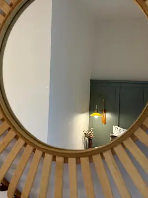 a stairway with a round mirror in a room at Cellar - Shared Pool & Nature Views in Spiliá
