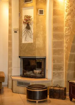 a fireplace in a living room with a fire place at Villa Chrysseva in Plátanos
