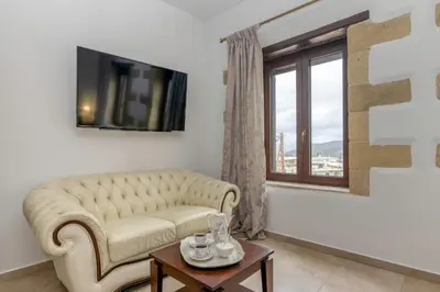 a living room with a couch and a window at Villa Chrysseva in Plátanos