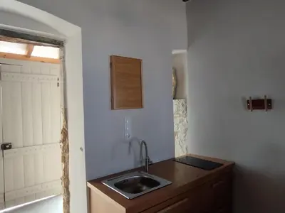 a small kitchen with a sink and a window at Meteoron Platanias in Plataniás