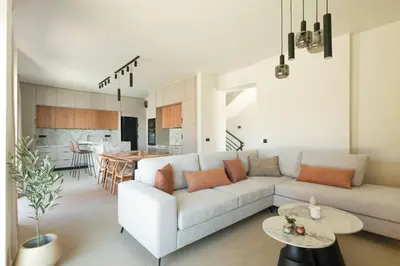 a living room with a couch and a table at Madre Tierra Boutique Villas 3 & 4 in Potistíria
