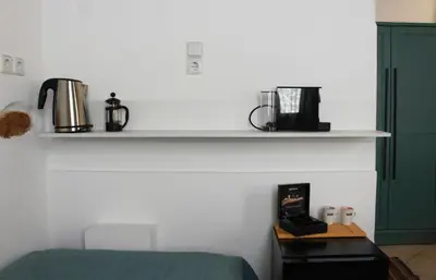 a bedroom with a bed and a shelf with coffee makers at casa di pietra in Chania Town