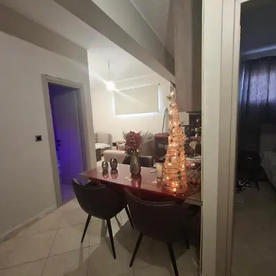a dining room table with a christmas tree on it at Αγίου Φανουρίου 5 γάλατα Χανιά Κρήτης in Galatás