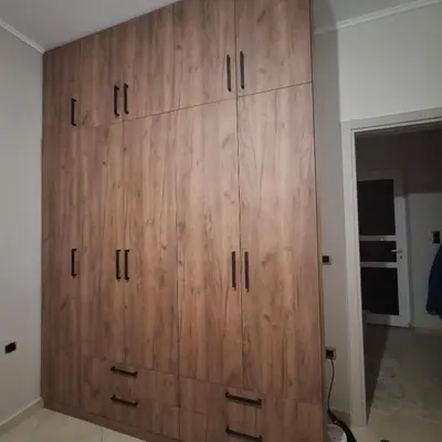 a large wooden cabinet in a room at Αγίου Φανουρίου 5 γάλατα Χανιά Κρήτης in Galatás