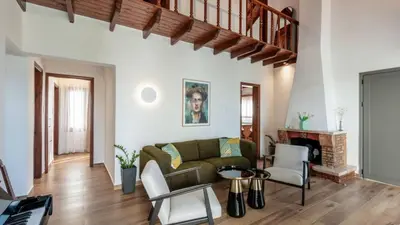 a living room with a couch and a fireplace at Two Seaview Villas With Elegant Design in Agios Onoufrios