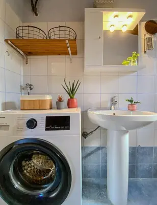 a washing machine and a sink in a kitchen at Alkis Olive Grove Cottage in Vasilópoulon