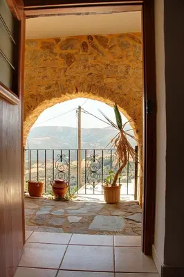 an archway in a building with a view of a mountain at Rogdia Mountain View Apartment in Rogdhiá