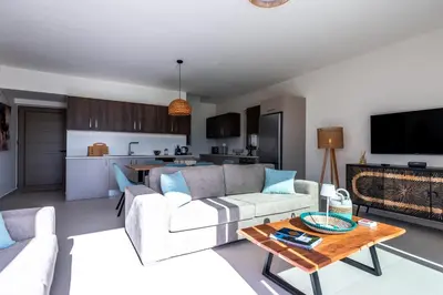 a living room with a couch and a table at Elpida Luxury Villa, private pool, fantastic view! in Stérnai