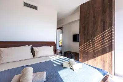 a bedroom with a bed with two towels on it at Elpida Luxury Villa, private pool, fantastic view! in Stérnai
