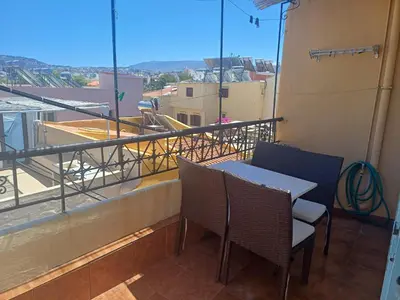 a table and chairs on a balcony with a view at House Minoos in Chania Town