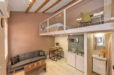 a living room with a couch and a bunk bed at Rea Studio 1 in Chania Town