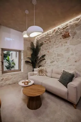 a living room with a couch and a table at HOLM Ilex & Quercus apartments in Chania Town