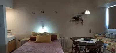 a room with a bed and a table with a dining room at 1st floor studio in Kalathas in Kalathas
