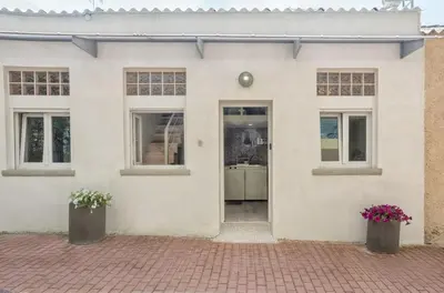 a white house with two potted plants in front of it at Rea Studio 2 in Chania Town