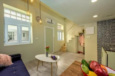 a living room with a couch and a table at Rea Studio 2 in Chania Town