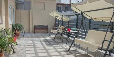 a patio with chairs and umbrellas on a balcony at Rea Studio 3 in Chania Town