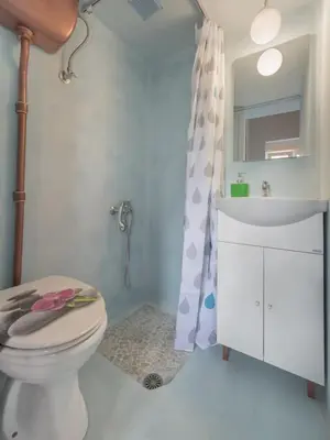 a bathroom with a toilet and a sink and a mirror at Rea Studio 3 in Chania Town
