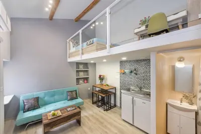 a living room with a blue couch and a sink at Rea Studio 3 in Chania Town