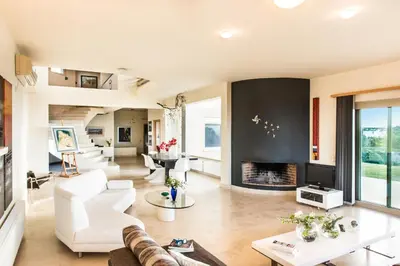 a living room with white furniture and a fireplace at Villa Mariposa - panoramic sea view - near Chania city in Chania Town