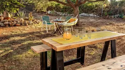 a wooden table with glasses on top of it at Lithos Serenity in Argoulidhés