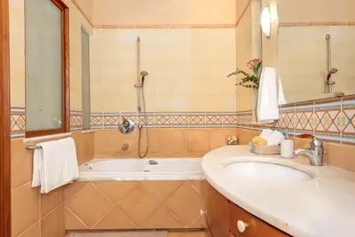 a bathroom with a sink and a bath tub at Lithos Serenity in Argoulidhés
