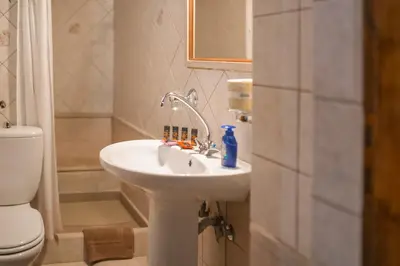 a bathroom with a sink and a toilet at Agapi's Charming Retreat - Rustic Escape in Chania in Maláxa