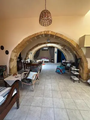 a room with an archway with chairs and tables at Casa Antica