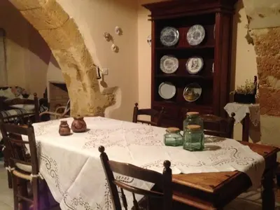 a dining room table with a white table cloth on it at Casa Antica