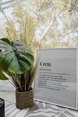 a sign next to a potted plant on a table at Lemon Dome, Luxury Glamping Dome in Crete in Gavalochori