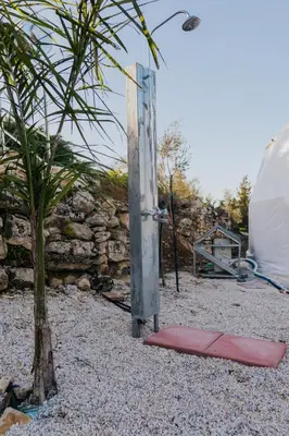 a tent and a red mat next to a tree at Lemon Dome, Luxury Glamping Dome in Crete in Gavalochori