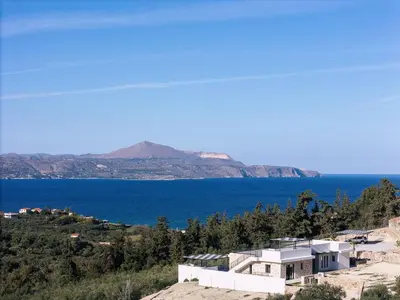 a house on a hill next to the ocean at Villa Maninee-Bespoke Villa-Pool -BBQ-Seaview in Chania Town