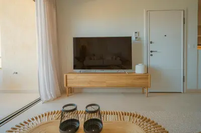 a living room with a large flat screen tv at Ocean Bay Sea View Apartment, Pool, Brand New, 2B in Kalyves