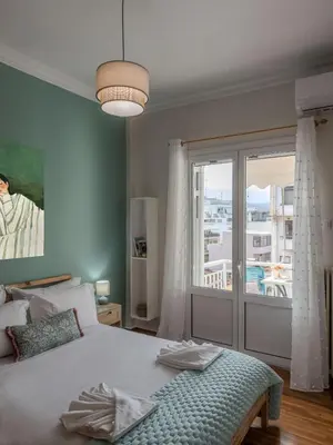 a bedroom with a bed and a large window at Sunny Nest, Stylish & Bright Urban Retreat in Chania Town