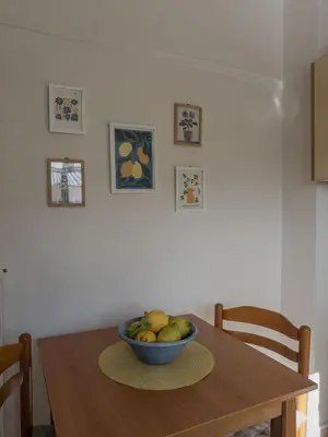 a wooden table with a bowl of fruit on it at Sunny Nest, Stylish & Bright Urban Retreat in Chania Town