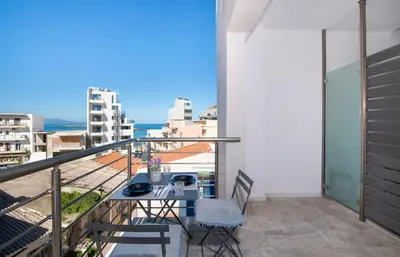 a balcony with a table and chairs and a view at Stelios Florans Apartment in Chania Town