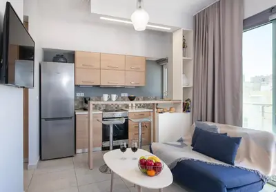 a kitchen and living room with a couch and a table at Stelios Florans Apartment in Chania Town