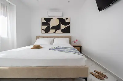 a bedroom with a bed with shoes on it at Villa Metochi with Private Pool in Palio Gerani