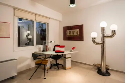 a room with a table and two chairs and a lamp at Villa Joy Mare - Seaside Escape with Private Pool in Aghii Apostoli