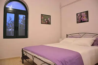 a bedroom with a bed and a window at 5-bedroom Country House in Crete - Olive Grove Retreat in Nerokhórion