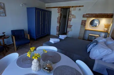a living room with a bed and a table at Vecia Abasia - The Old Abbey in Chania Town
