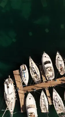 a group of boats docked on a dock in the water at 3 Sails - 2BR on Venetian Harbour with Balcony in Chania Town