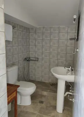 a bathroom with a toilet and a sink at Vrahakia Apartment 1 in Marina Galatas in Galatás