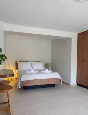 a bedroom with a bed with two plates on it at Vrahakia Apartment 1 in Marina Galatas in Galatás